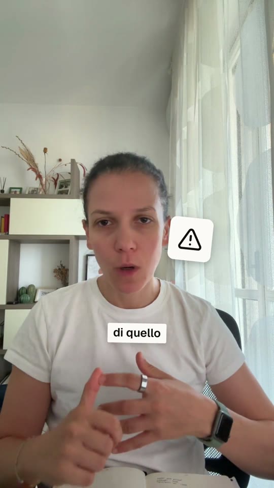 Fotogramma del reel: una persona parla verso la camera, accanto al volto un adesivo con un triangolo di avviso e, sotto, il sottotitolo su una striscia di carta.